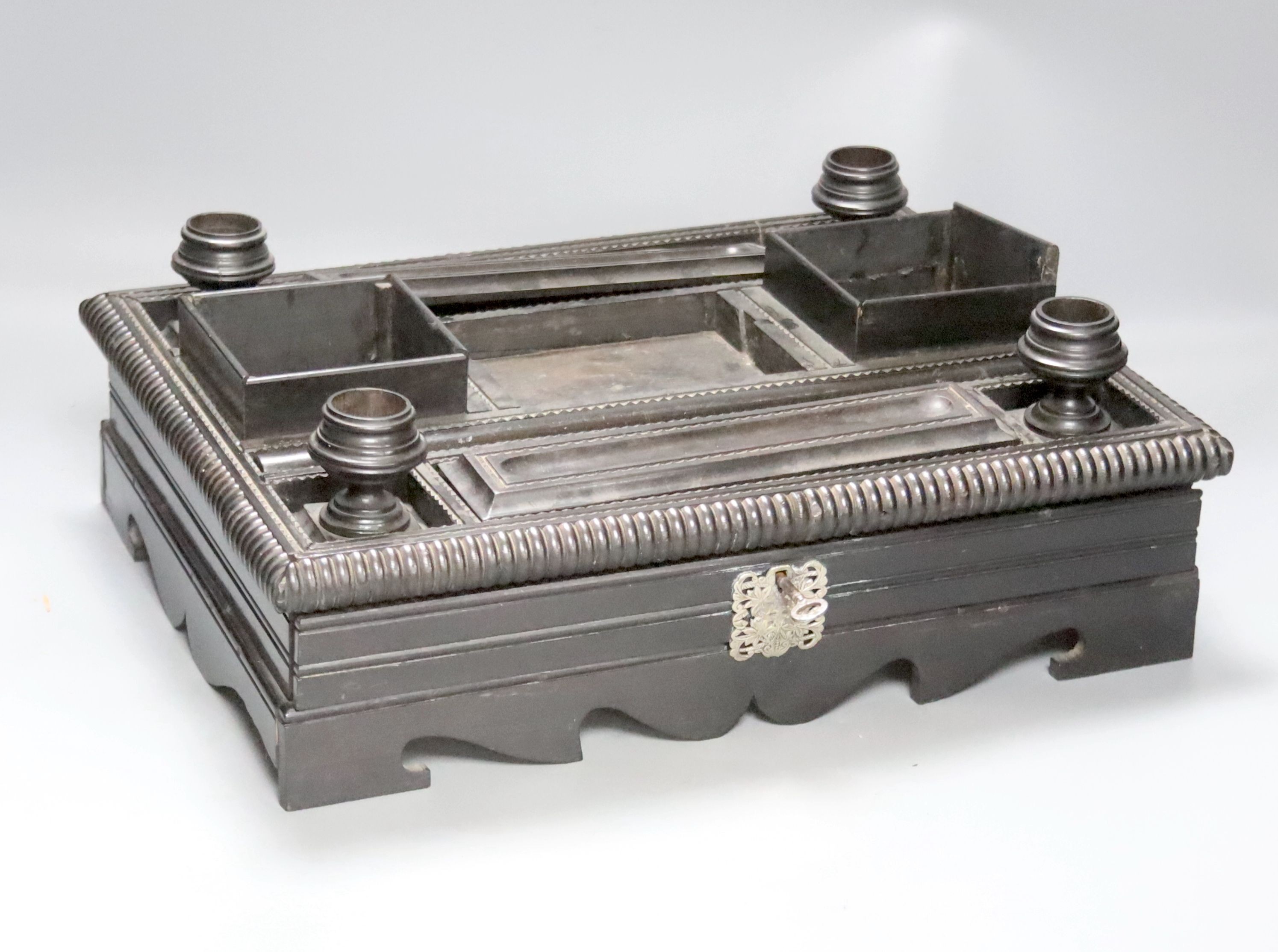 A 19th century Indo-Colonnial ebony desk stand, single drawer with engraved white metal escutcheon, width 37cm